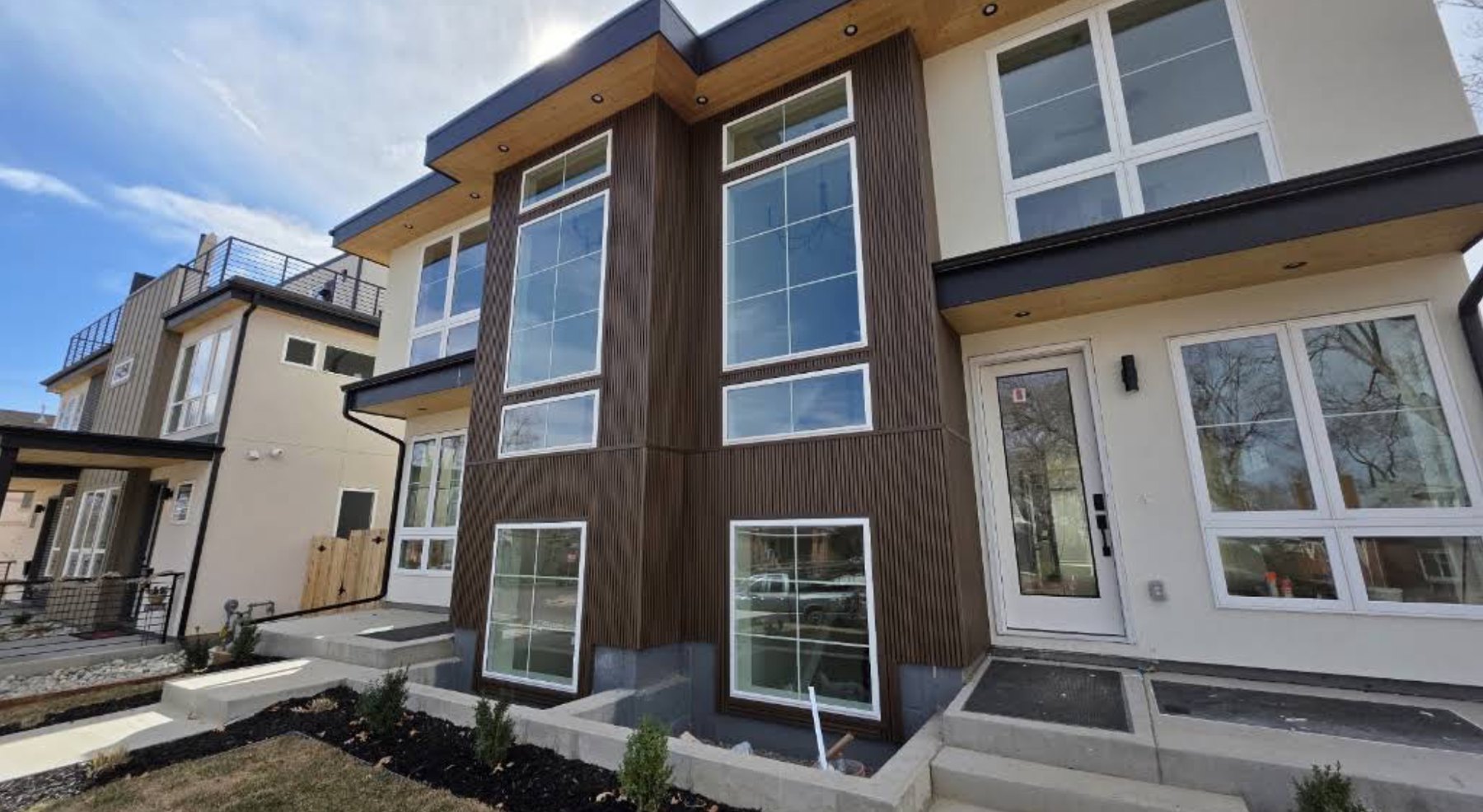 Modern two-story infill home with vertical wood siding