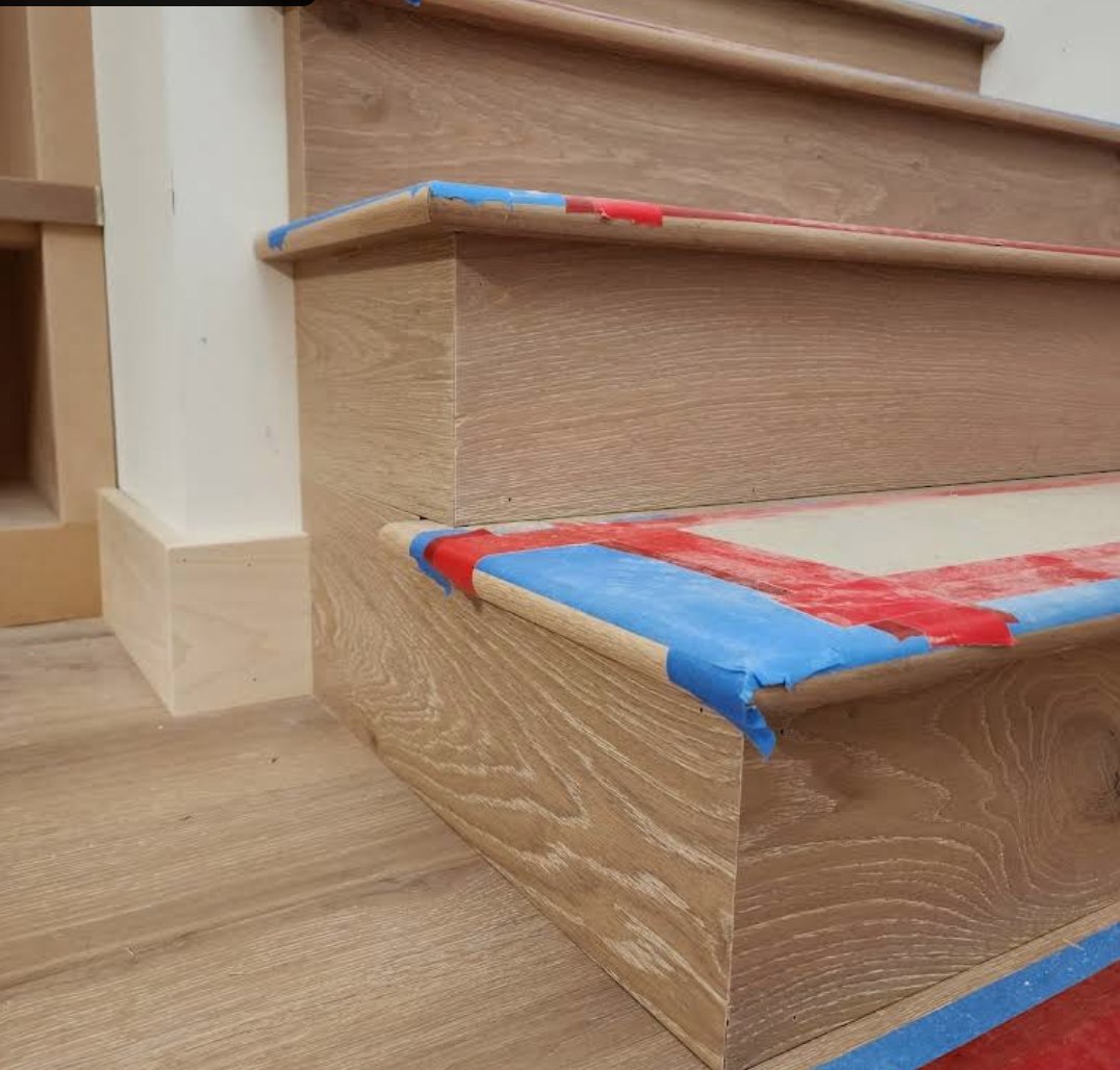 White oak treads and risers with tape protecting the nosing